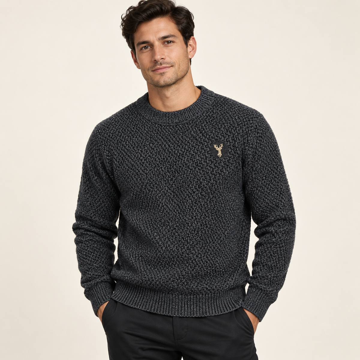 Male model wearing charcoal textured crewneck sweater with gold deer chest embroidery