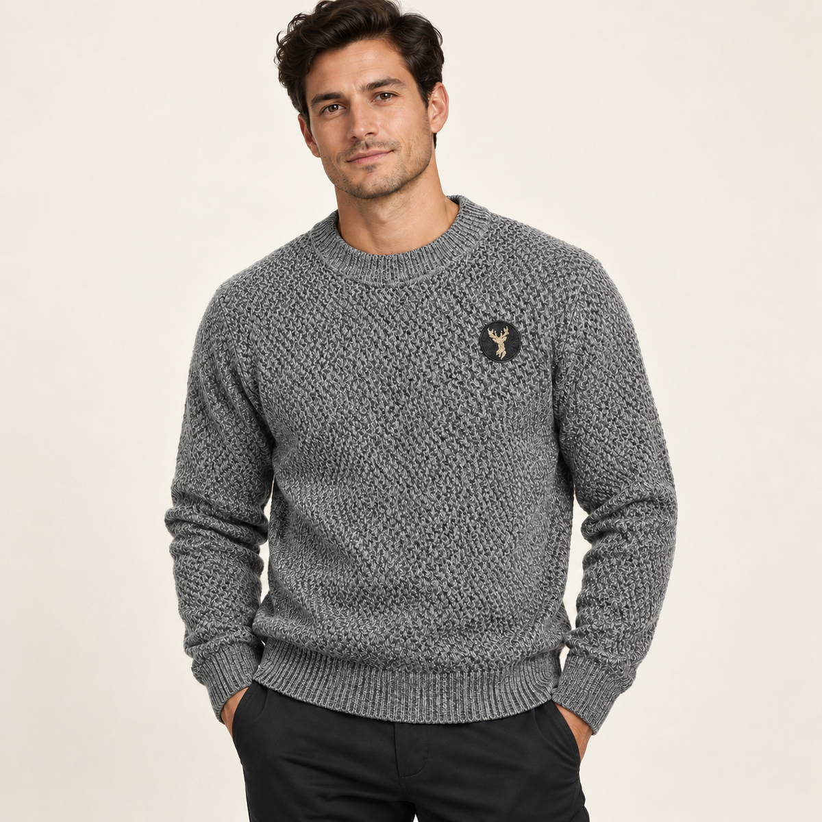 Male model wearing gray textured crewneck sweater with gold deer embroidery