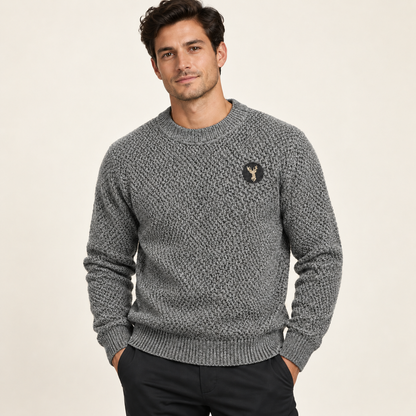 Male model wearing gray textured crewneck sweater with gold deer embroidery