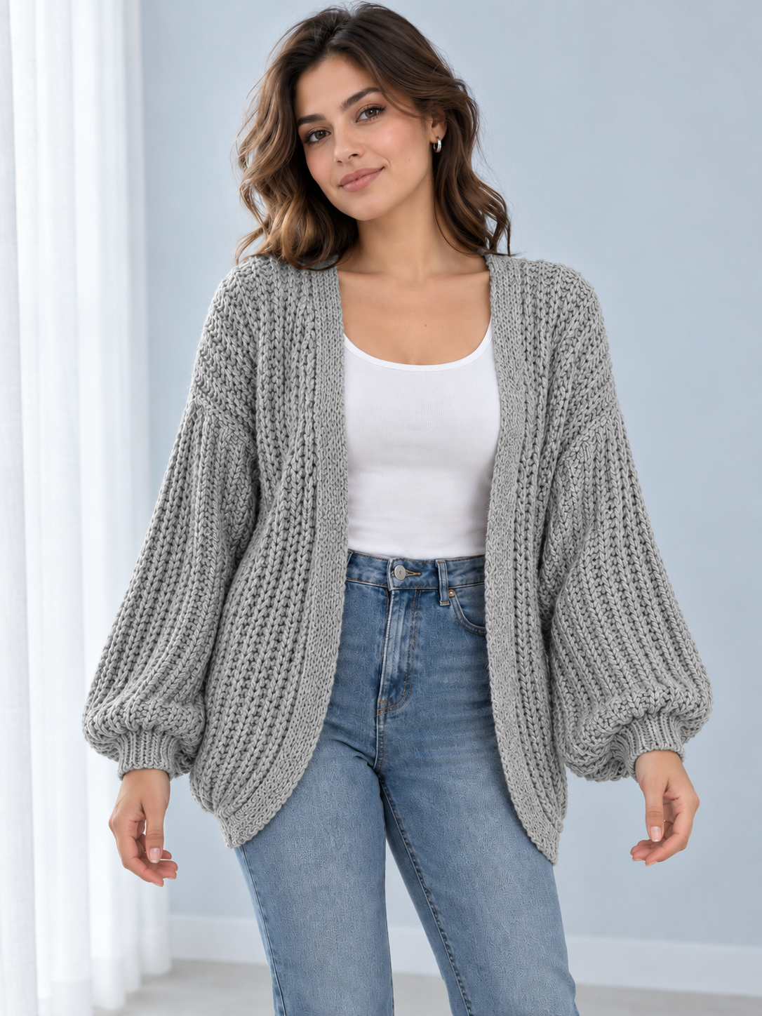 Female model wearing gray open-front lantern-sleeve cardigan, front view