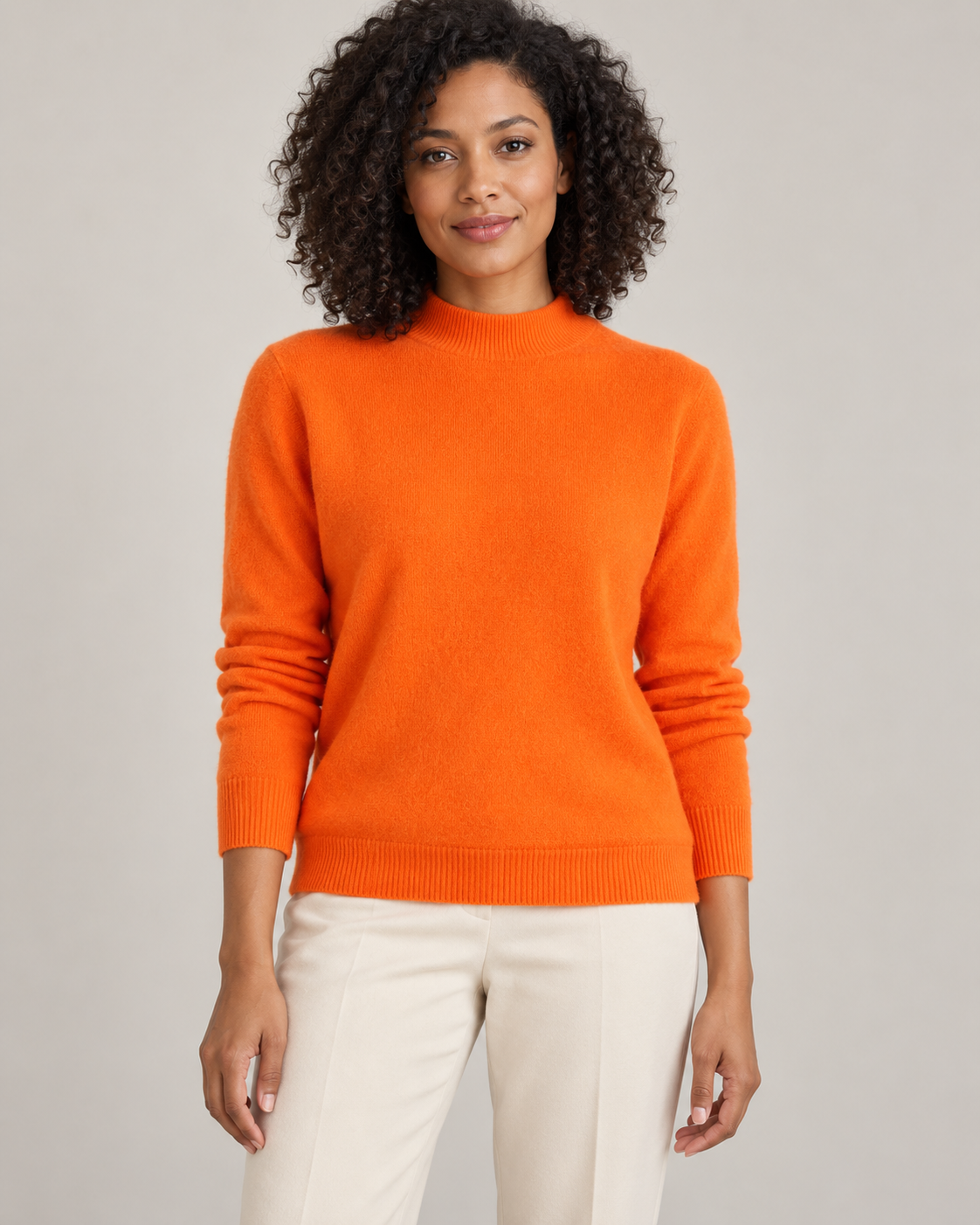 Orange mock-neck sweater on a model