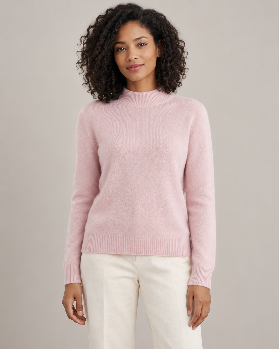 Blush pink mock-neck sweater on a model